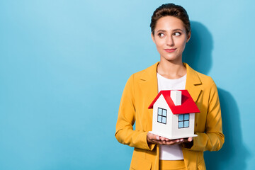 Poster - Photo portrait woman in suit smiling keeping little house looking copyspace isolated pastel blue color background