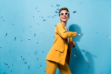 Poster - Portrait of attractive cheerful woman having fun dancing seuins flying festive event isolated over bright blue color background