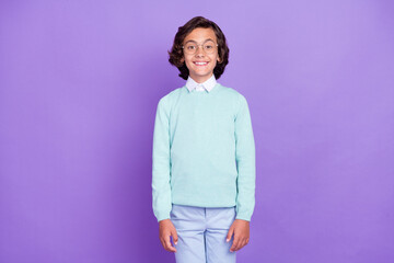 Sticker - Photo of small nice brunet boy wear blue sweater spectacles isolated on purple background