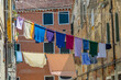 narrow road in Venice with clotheslines between the old venetian houses