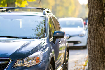 Canvas Print - New clean car parked on a city street side.