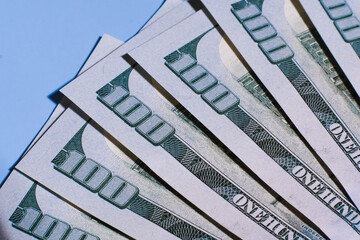 American dollar banknotes close up. Americans dollars macro shooting. Inflation concept. Closeup new american one hundred dollar bills. New hundred dollar bills blue background .