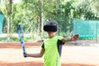 © Anna - Close up image of boy in VR glasses in sport uniforn and with tennis racquet training kick with help of virtual training. New reality, sport training in cyberspace