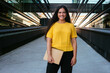 © Cavan Images - Portrait of a young business woman smiling at camera