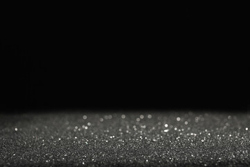 Wall Mural - shiny grey glitter on black background, space for text. bokeh effect