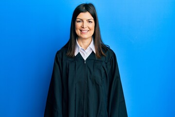 Wall Mural - Young hispanic woman wearing judge uniform with a happy and cool smile on face. lucky person.