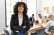 © Krakenimages.com - Young middle east businesswoman smiling happy standing with arms crossed gesture at the office during business meeting.