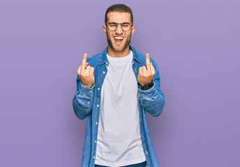 Poster - Young caucasian man wearing casual clothes showing middle finger doing fuck you bad expression, provocation and rude attitude. screaming excited