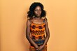 © Krakenimages.com - Young african american woman wearing traditional african clothes skeptic and nervous, frowning upset because of problem. negative person.