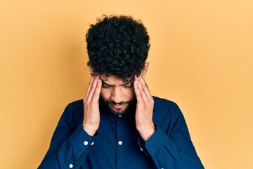 Canvas Print - Young arab man with beard wearing casual shirt with hand on head for pain in head because stress. suffering migraine.