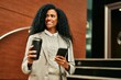 © Krakenimages.com - Middle age african american businesswoman using smartphone and drinking coffee at the city.