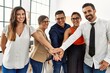 © Krakenimages.com - Group of business workers smiling happy standing with hands together at the office.