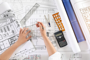 Architect Drawing Blueprint At Desk In Office