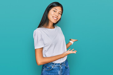 Poster - Beautiful young asian woman wearing casual white t shirt inviting to enter smiling natural with open hand