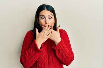 Canvas Print - Beautiful brunette woman wearing wool winter sweater shocked covering mouth with hands for mistake. secret concept.