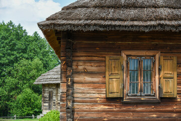 Peasant wooden house with thatched roof