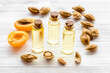 Bottles of apricot kernel oil with ripe apricot fruits