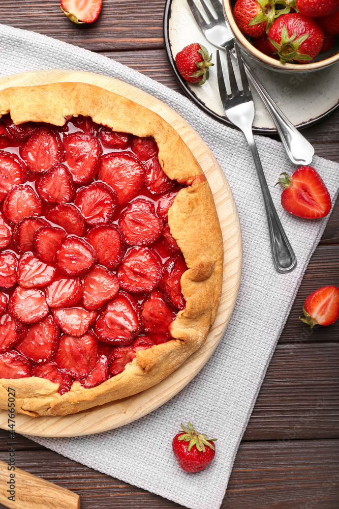 Composition with tasty strawberry pie on dark wooden background