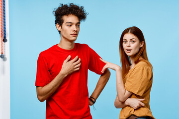 man and woman in colorful t-shirts communication youth style blue background