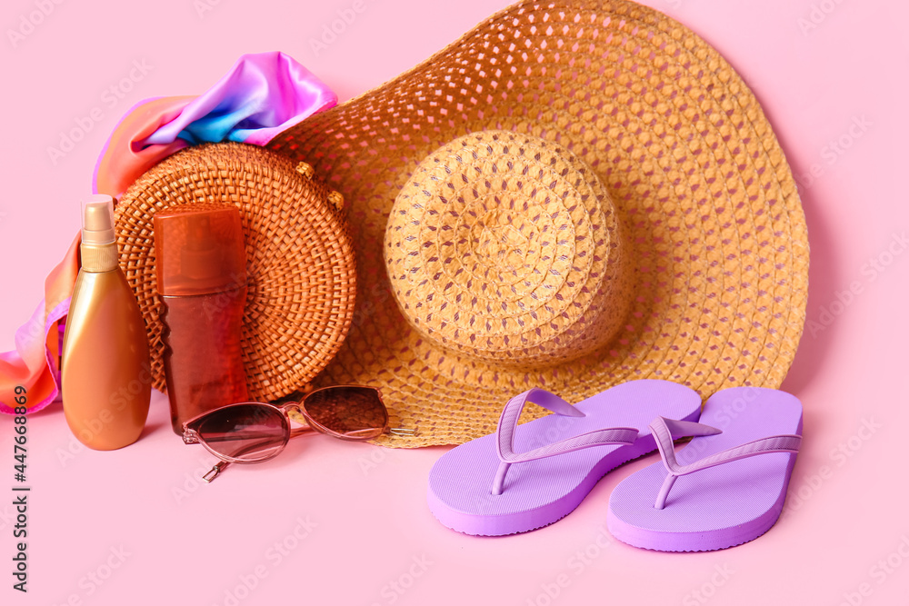 Set of beach accessories on color background
