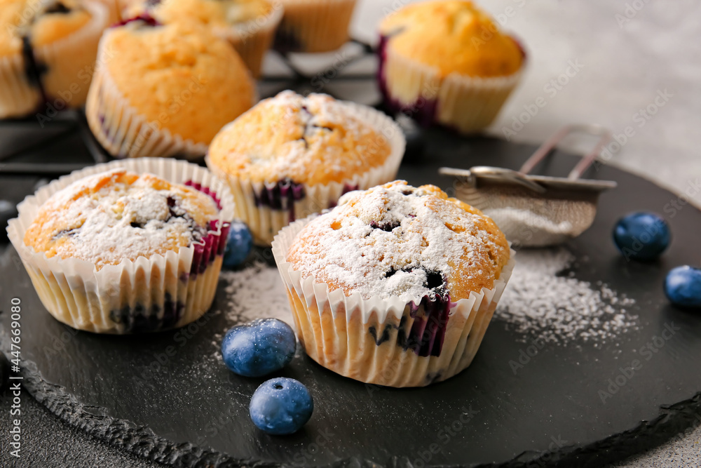 Tasty blueberry muffins on table, closeup