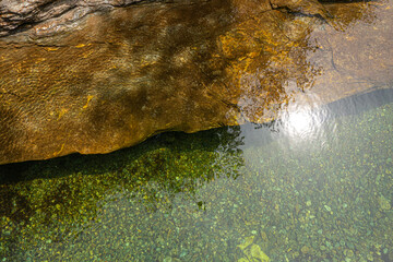 Top view of the water of a river and a rock bank. The wind gives the whole a superb texture. On the GR 70, Robert Louis Stevenson Trail, Cevennes, France