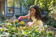 © Wavebreak Media - Mixed race girl planting flowers in backyard