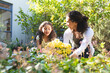 © Wavebreak Media - Mixed race mother and daughter planting flowers and talking