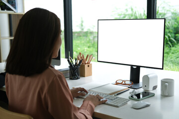 Closed up with businesswoman working with computer PC, blank screen of display computer.