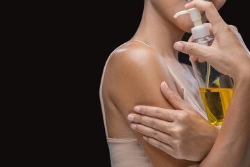 Wall Mural - A woman is applying olive oil to her skin.