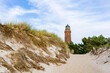 View from the beach to the Darsser Ort lighthouse on the German Baltic Sea coast....