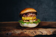 Burger with marinated onion and pineapple on wooden board