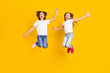 © deagreez - Full length body size view of two nice crazy cheerful carefree kids jumping having fun fooling isolated over bright yellow color background