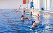 © ADDICTIVE STOCK - Company of people doing exercise with aqua noodles during water aerobics