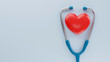 Red heart and stethoscope on a blue background with copy space. 3D image