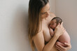© ADDICTIVE STOCK - Gentle mother with sleeping newborn at home