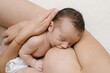 © ADDICTIVE STOCK - Anonymous mother breastfeeding baby in room at home