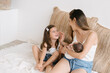 © ADDICTIVE STOCK - Mother with kids on sofa at home