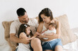 © ADDICTIVE STOCK - Happy family with kids on sofa at home