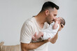 © ADDICTIVE STOCK - Caring father with newborn at home