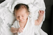 © ADDICTIVE STOCK - Adorable newborn sleeping on bed