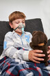 © ADDICTIVE STOCK - Content sick boy in oxygen mask playing with toy