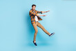 © deagreez - Photo of friendly cute young guy dressed plaid shirt smiling jumping high isolated blue color background