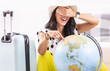 Blindfolded lady is randomly choosing her holiday destination on globe