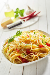 Wall Mural - Portion of tasty spaghetti with cheese, red pepper, and basil leaf