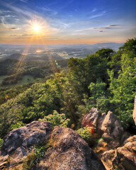 Beautiful sunset and clouds in Rudawy Janowickie (Mountains in south-west Poland, Europe). View from Krzyzna Gora (654 m above sea level) in the middle of July.