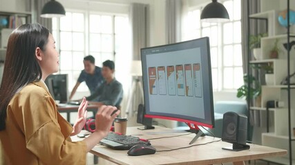Asian Female Mobile Application Developer Stretching While Works With Graphics On Her Personal Computer In Office

