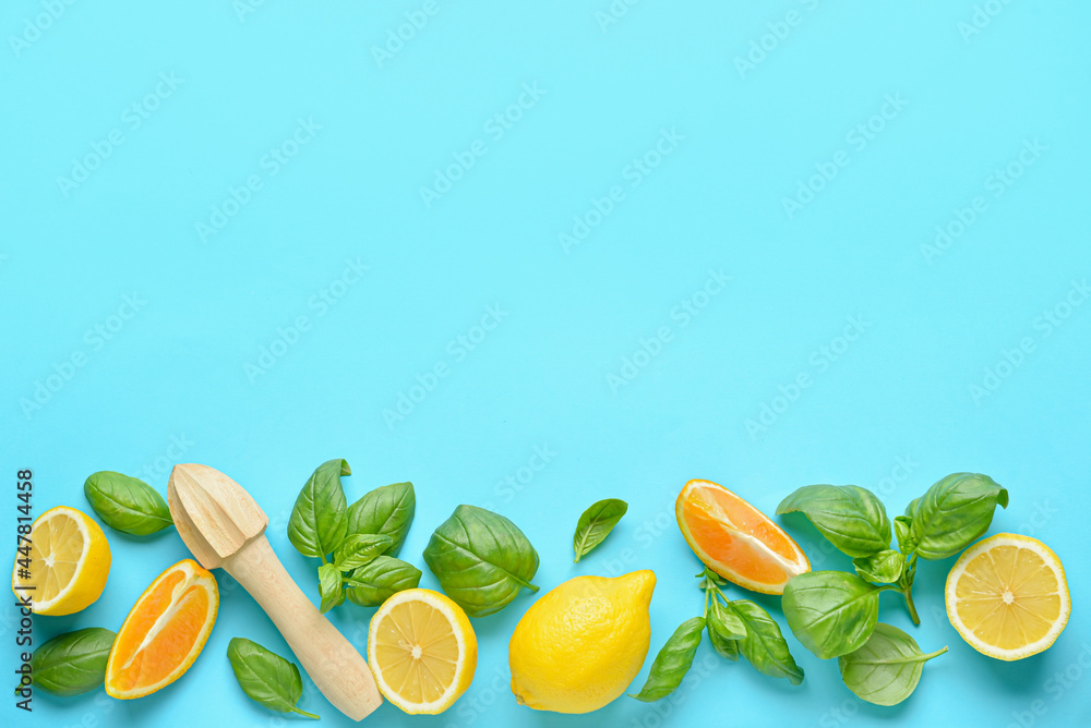 Basil leaves and citrus fruits on color background