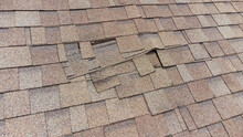 Damaged Roof Shingles In Need Of Repair