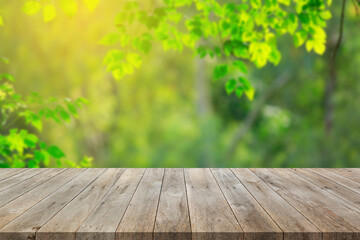 Wall Mural - Wood floor with blurred trees of nature park background and summer season, product display montage